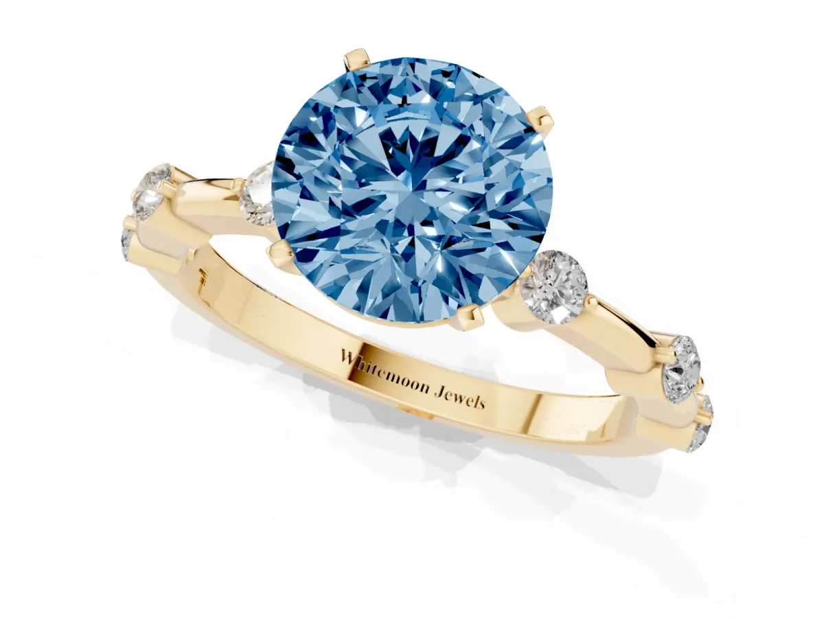 Fancy Blue Round Cut Solitaire Diamond Ring with Bezel Set Side Stones and Prong Setting Yellow gold