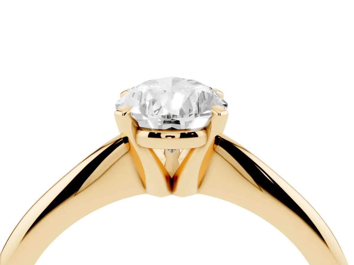 Pear Cut Cut Solitaire Ring with Four-Prong Setting on a Classic Band Yellow gold