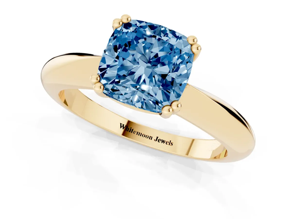 Fancy Blue Cushion Cut Cut Solitaire Engagement Ring with Tapered Band and Four-Prong Setting Yellow gold