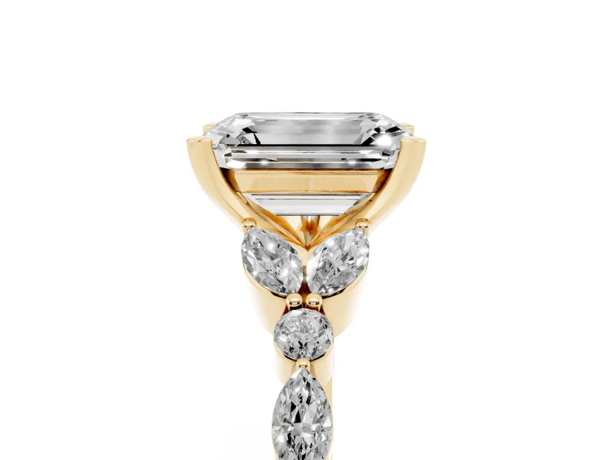 Emerald Cut Diamond Solitaire Ring with Side Stones and Four-Prong Setting Yellow gold