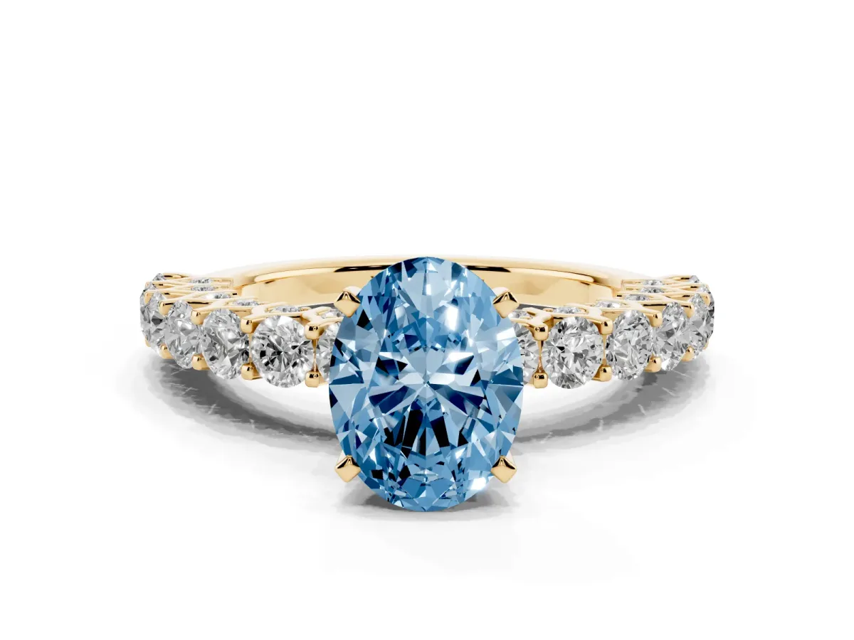 Fancy Blue Oval Cut Diamond Solitaire Ring with Shared Prong Pavé Band and Four-Prong Setting Yellow gold