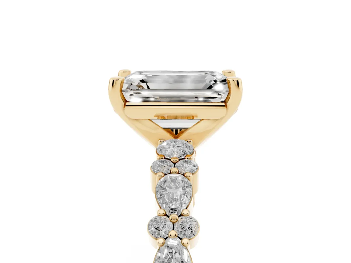 Emerald Cut Diamond Side Stone Solitaire Ring with Round and Four-Prong Setting Yellow gold