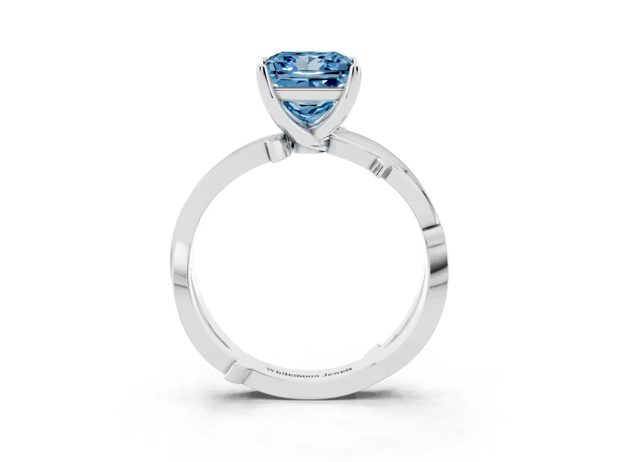 Fancy Blue Princess Cut Solitaire Twist Band with Pavé Accents and Four-Prong Setting Silver