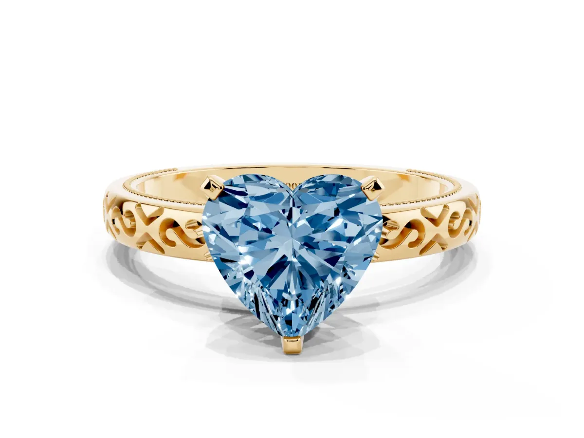 Fancy Blue Heart Cut Solitaire Engagement Ring with Scrollwork Band and Four-Prong Setting Yellow gold