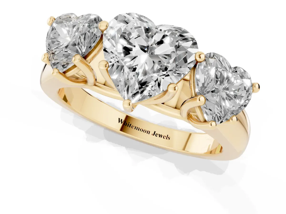 Heart Cut Three-Stone Diamond Ring with Prong Setting on a Classic Band Yellow gold