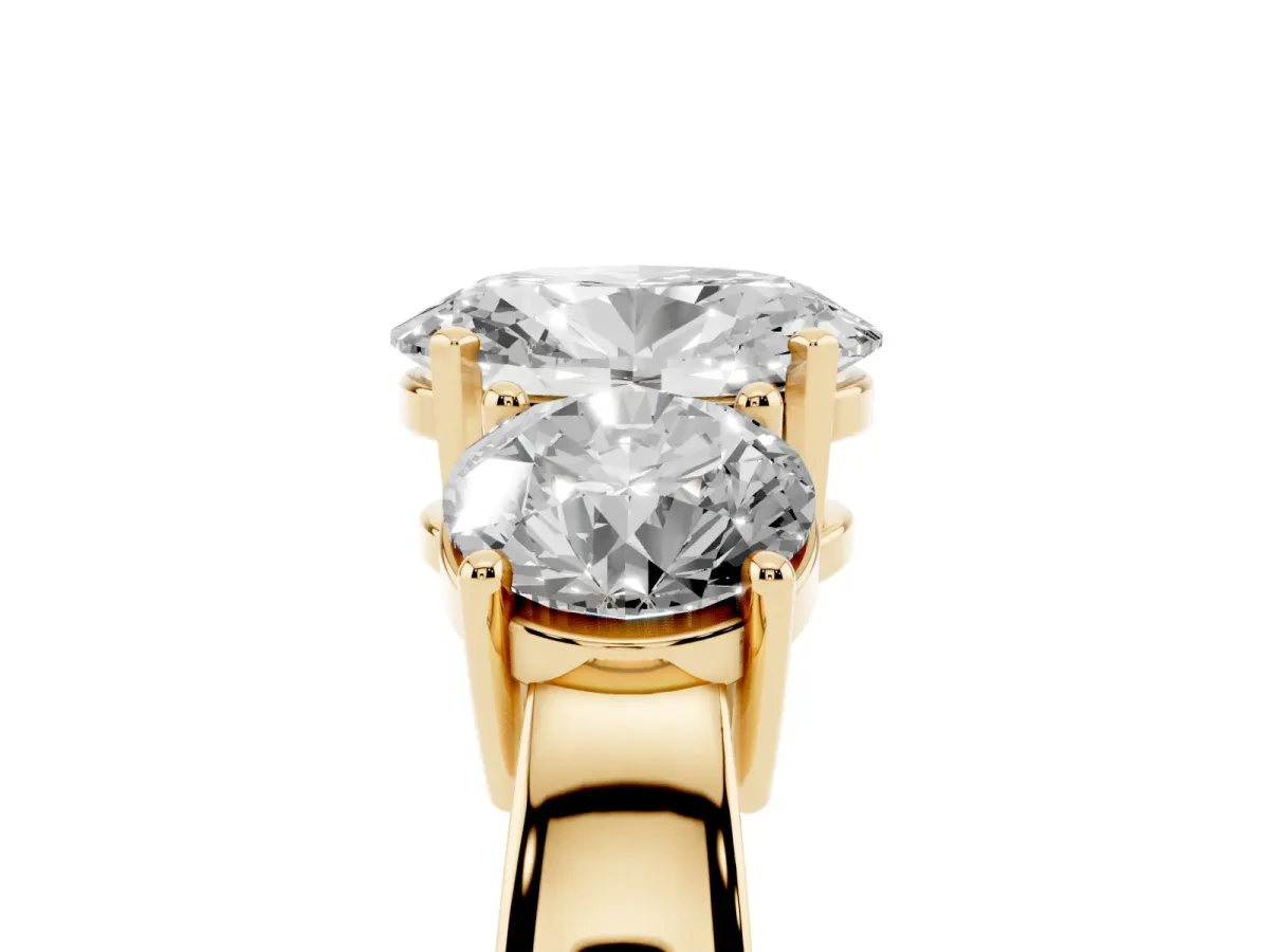 Three-Stone Oval Cut Diamond Ring with Round Side Stones, Classic Band, and Four-Prong Setting Yellow gold