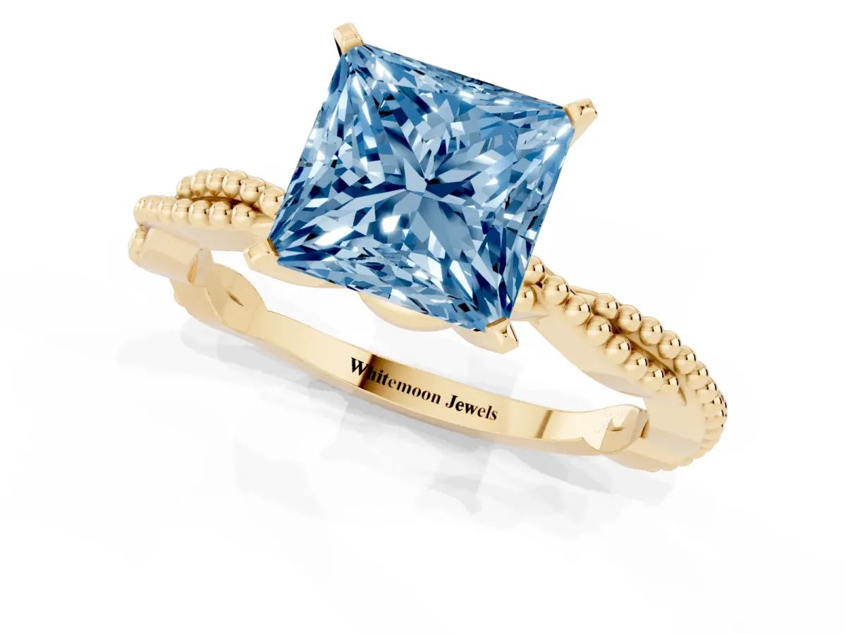 Fancy Blue Princess Cut Solitaire Twisted Band with Bead Prong Setting Yellow gold