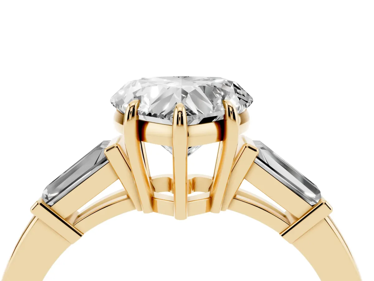 Heart Cut Diamond Three-Stone Ring with Tapered Baguette Side Stones and Prong Setting Yellow gold