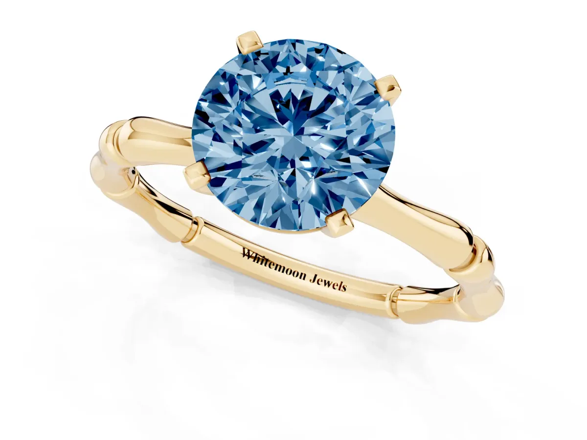 Fancy Blue Round Cut Solitaire Diamond Ring with Bamboo Band and Four-Prong Setting Yellow gold
