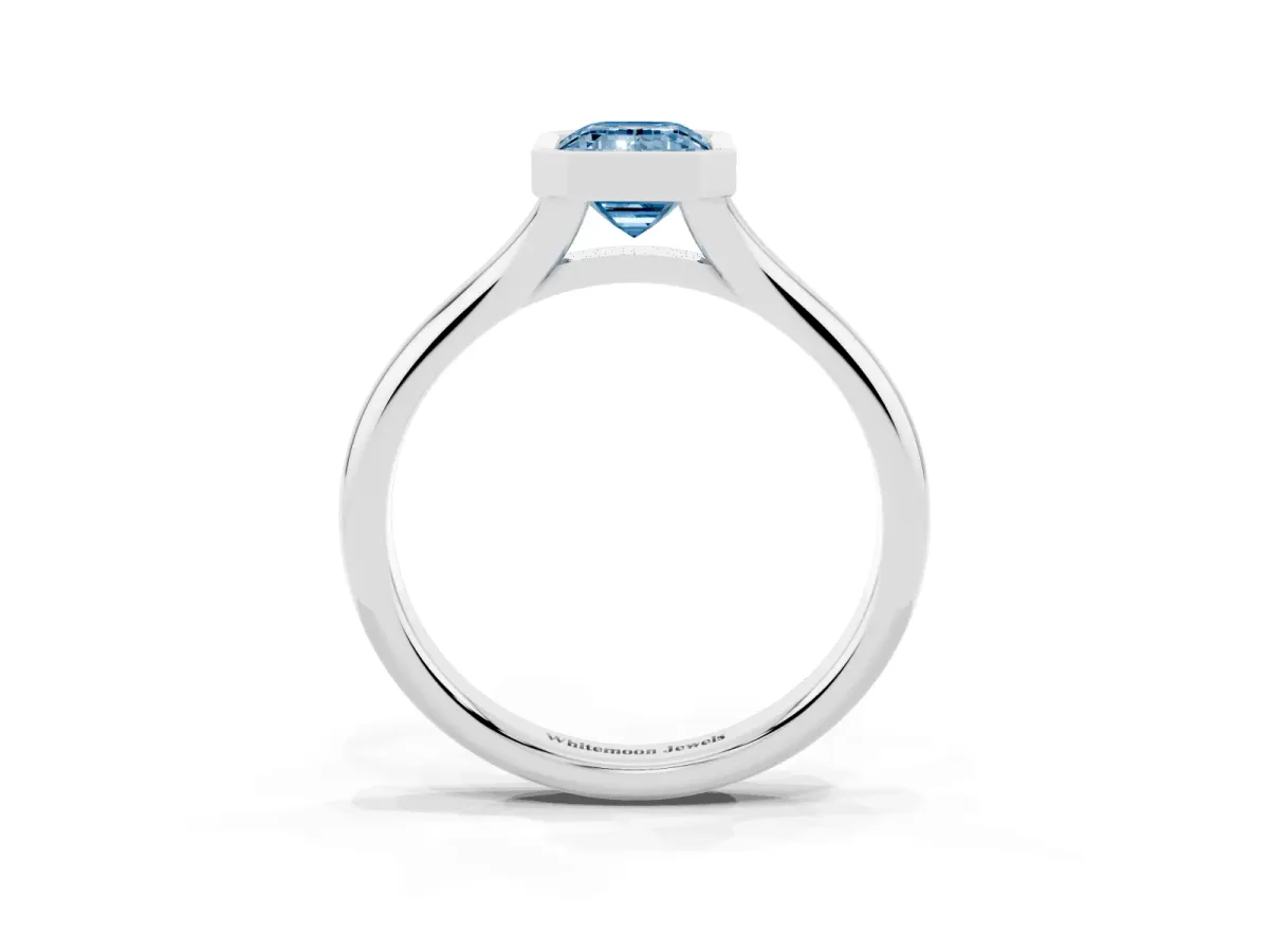Fancy Blue Bezel Set Emerald Cut Solitaire Diamond Ring with Smooth Band Silver