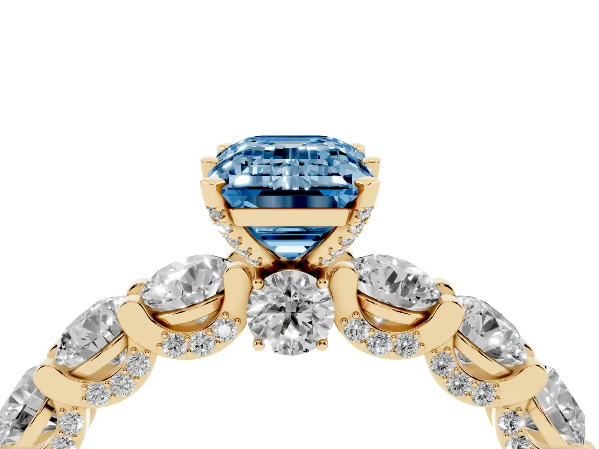 Fancy Blue Emerald Cut Diamond Side Stone Engagement Ring with Four-Prong Setting Yellow gold