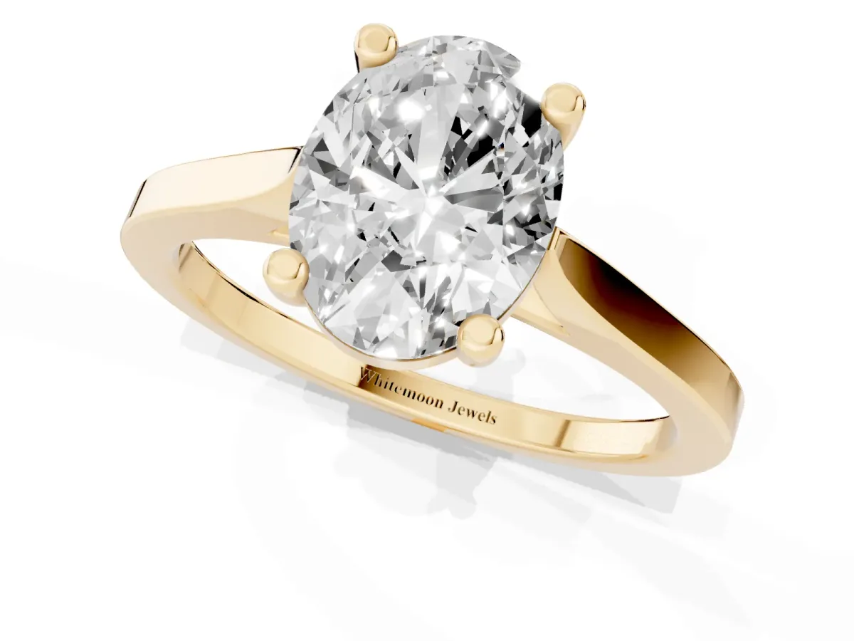 Oval Cut Solitaire Diamond Ring with Four-Prong Setting and Tapered Band Yellow gold