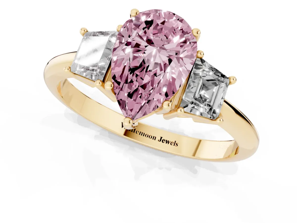 Fancy Pink Pear Cut Diamond Three-Stone Ring with Trapezoid Side Stones and Prong Setting Yellow gold