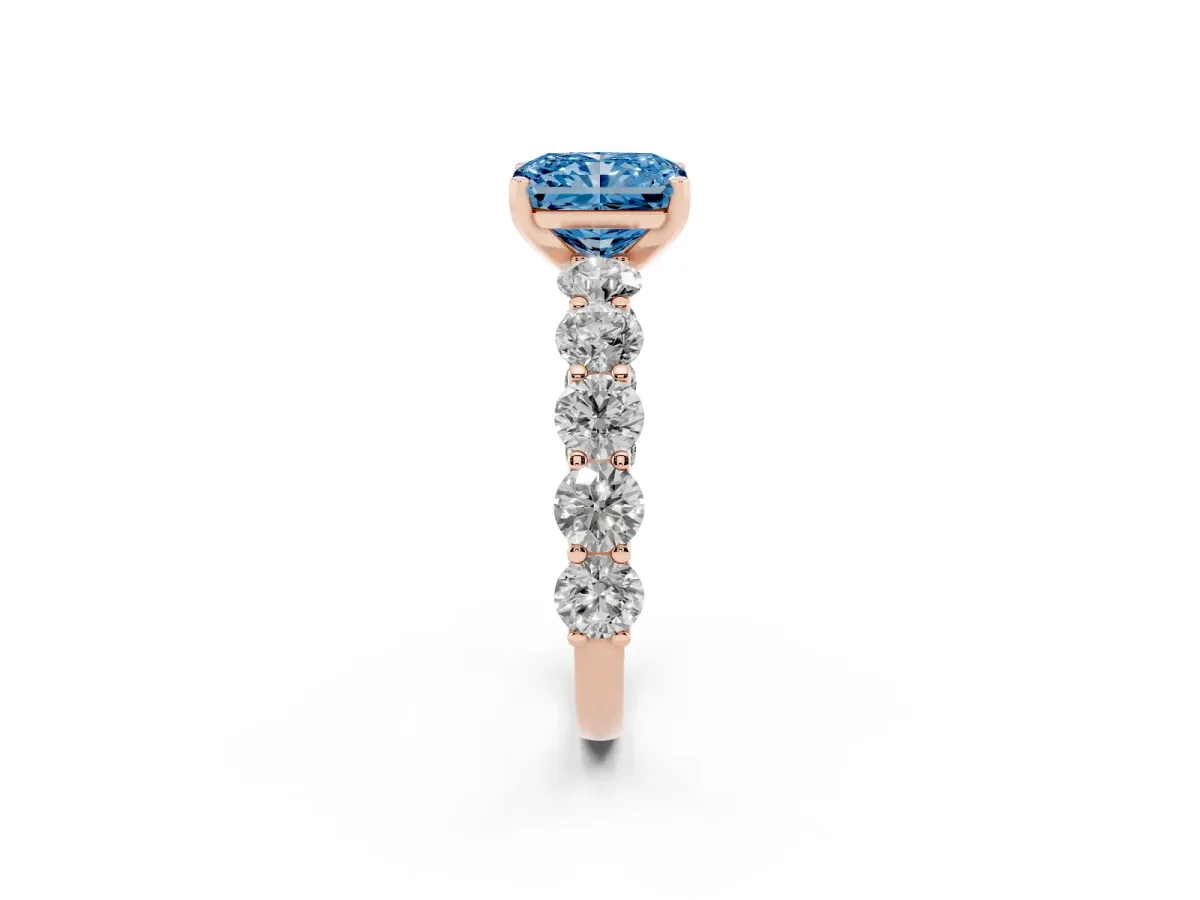 Fancy Blue Radiant Cut Diamond Prong Setting with Side Stones on a Pave Band Rose gold