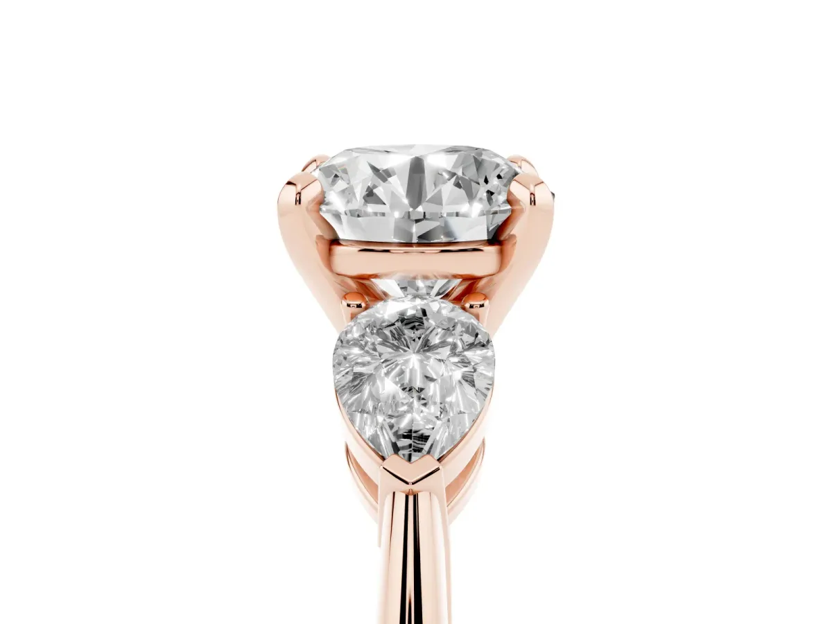 Three-Stone Round Cut Diamond Ring with Pear Side Stones and Four-Prong Setting Rose gold