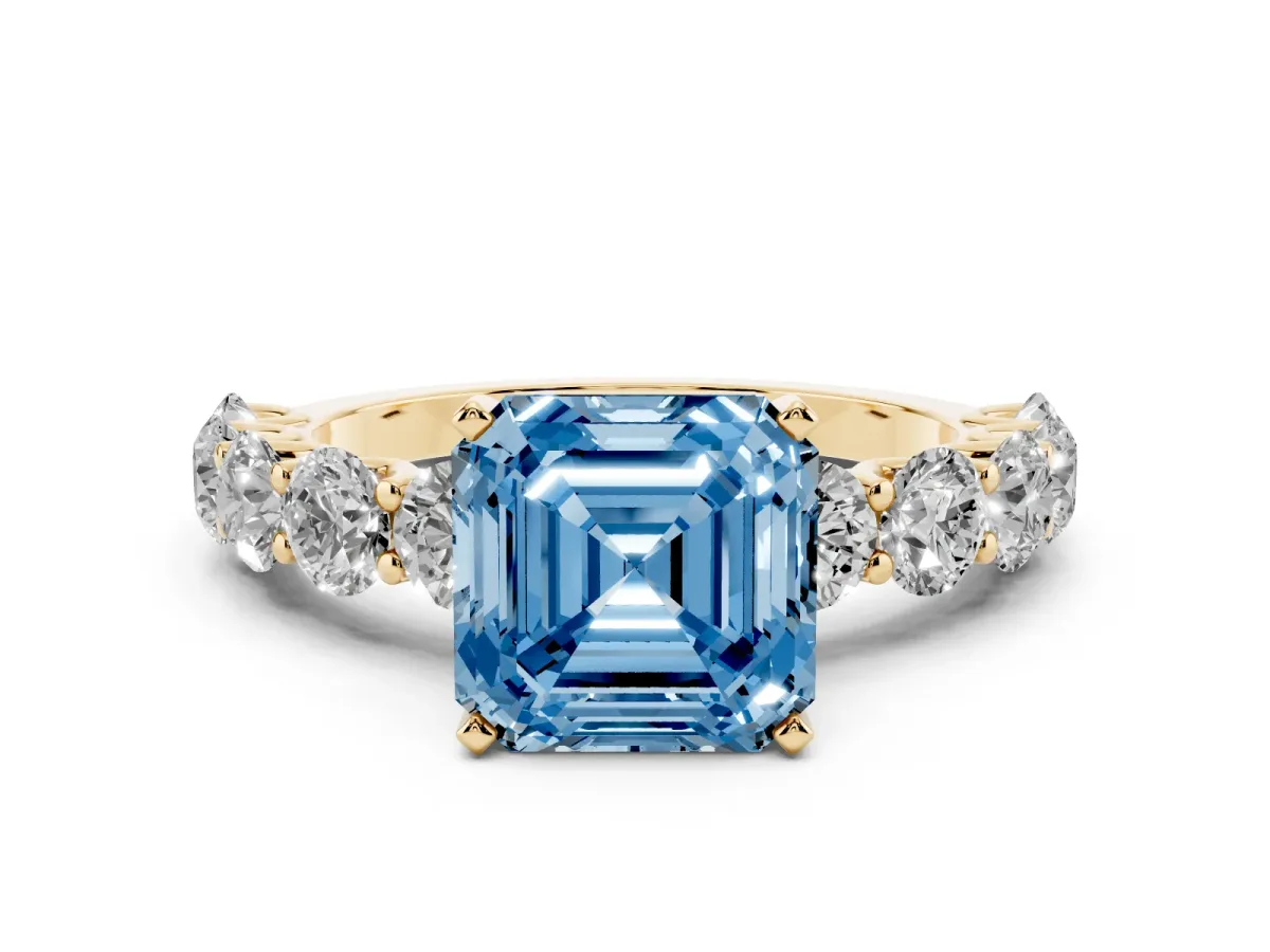 Fancy Blue Asscher Cut Diamond Prong Setting with Side Stones on a Pave Band Yellow gold