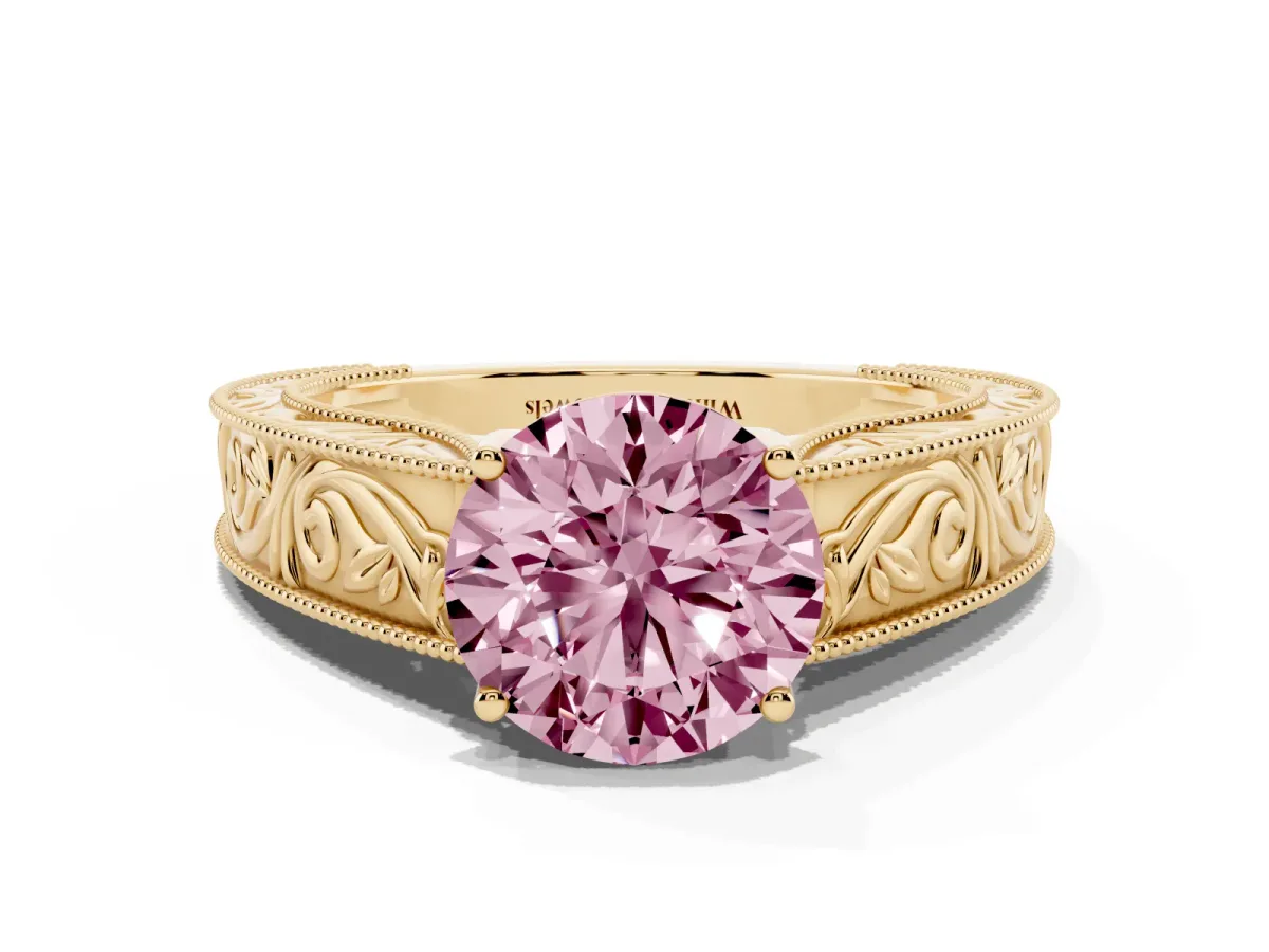 Fancy Pink Round Cut Diamond Solitaire Ring with Engraved Band and Four-Prong Setting Yellow gold