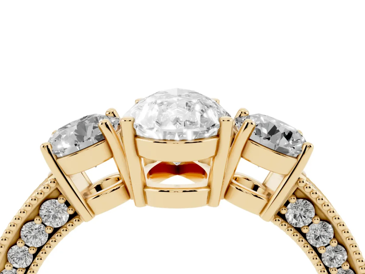 Pear Cut Three-Stone Diamond Ring with Pavé Band and Four-Prong Setting Yellow gold