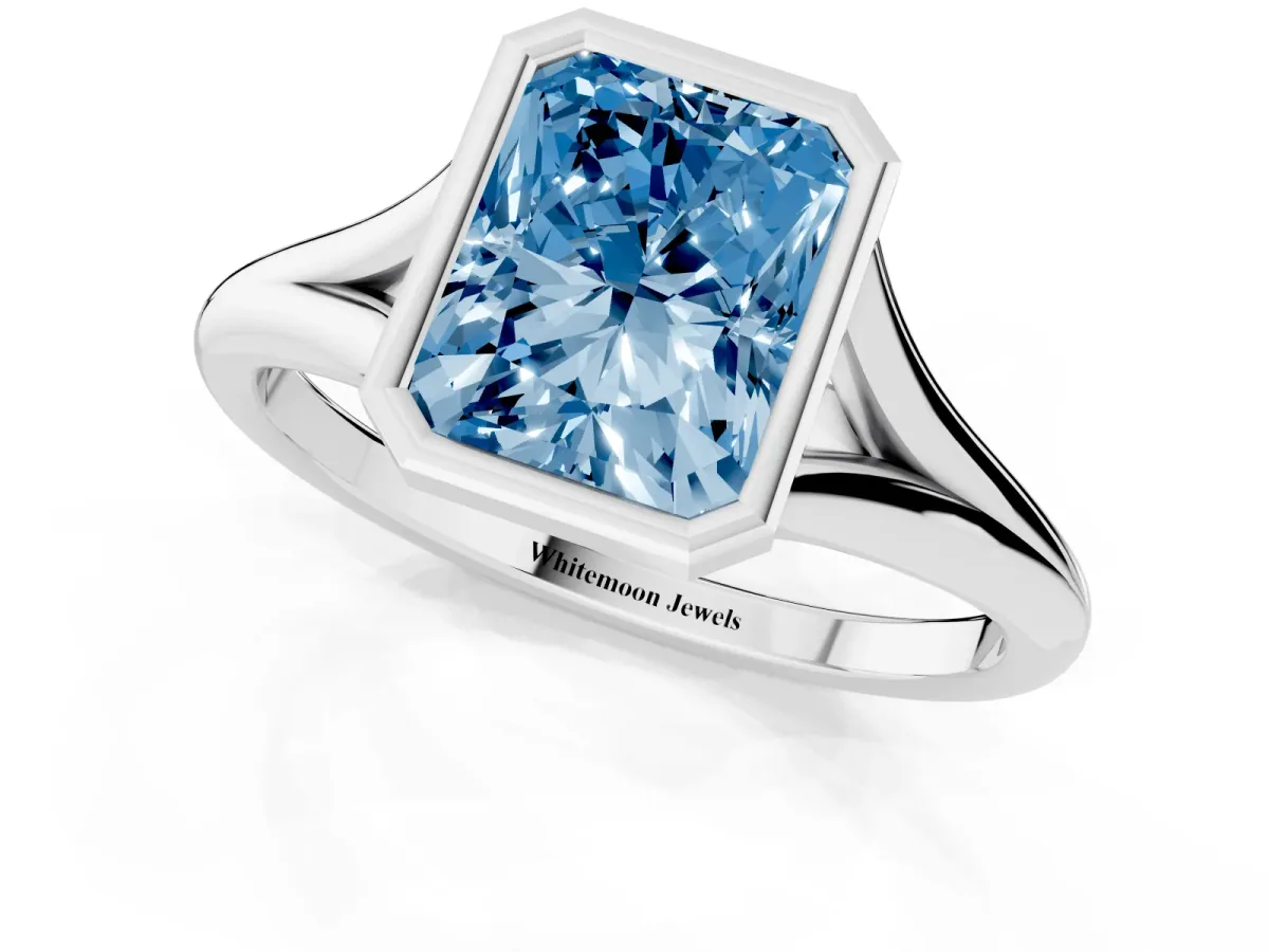 Fancy Blue Bezel Set Radiant Cut Cut Solitaire Ring with Tapered Band Silver