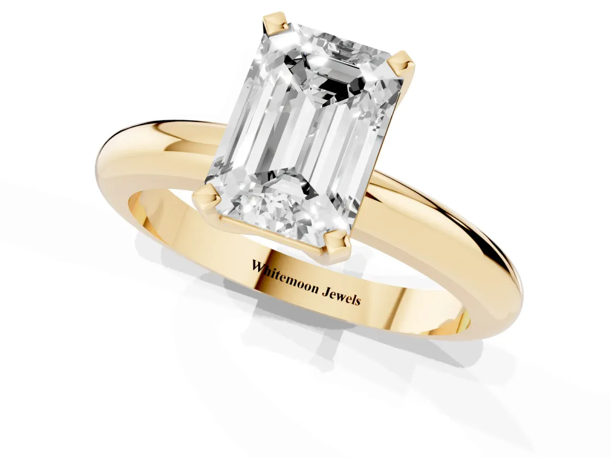 Emerald Cut Diamond Solitaire Engagement Ring with Round Band and Four-Prong Setting Yellow gold
