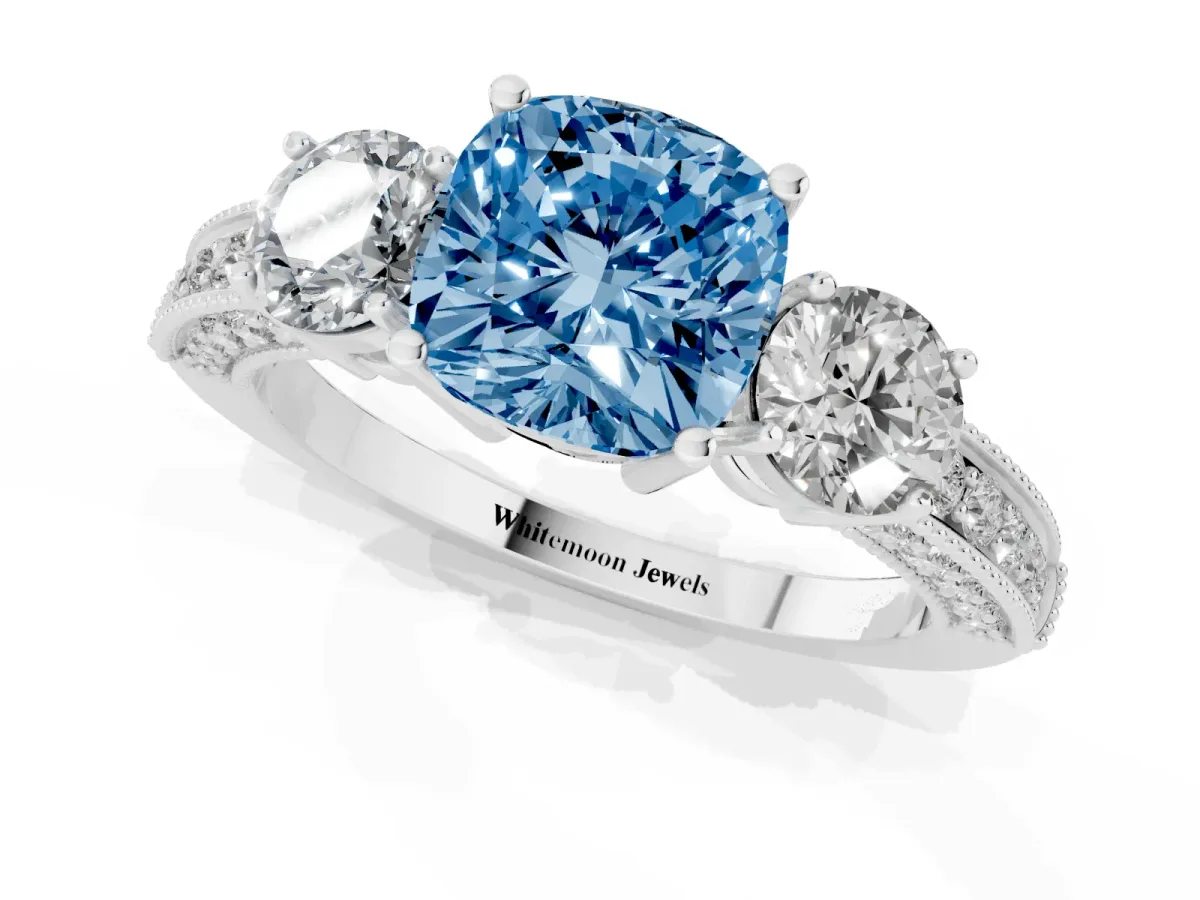 Fancy Blue Cushion Cut Three-Stone Diamond Ring with Pavé Band and Four-Prong Setting Silver