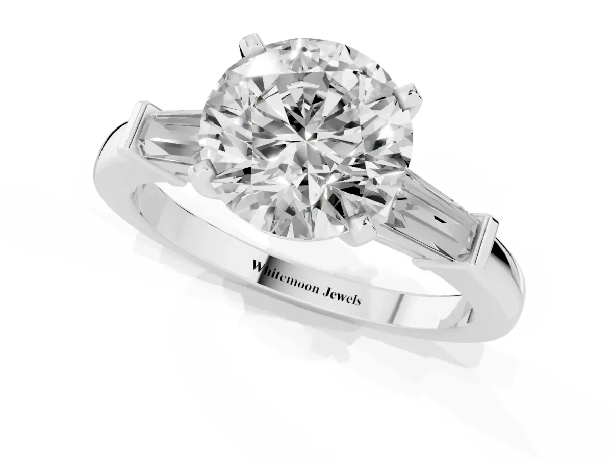 Round Cut Cut Diamond Solitaire Ring with Tapered Baguette Accents and Four-Prong Setting White gold