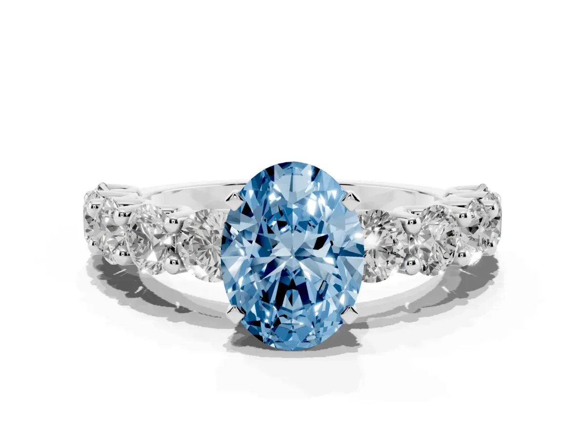 Fancy Blue Oval Cut Diamond Prong Setting with Side Stones on a Pave Band Silver