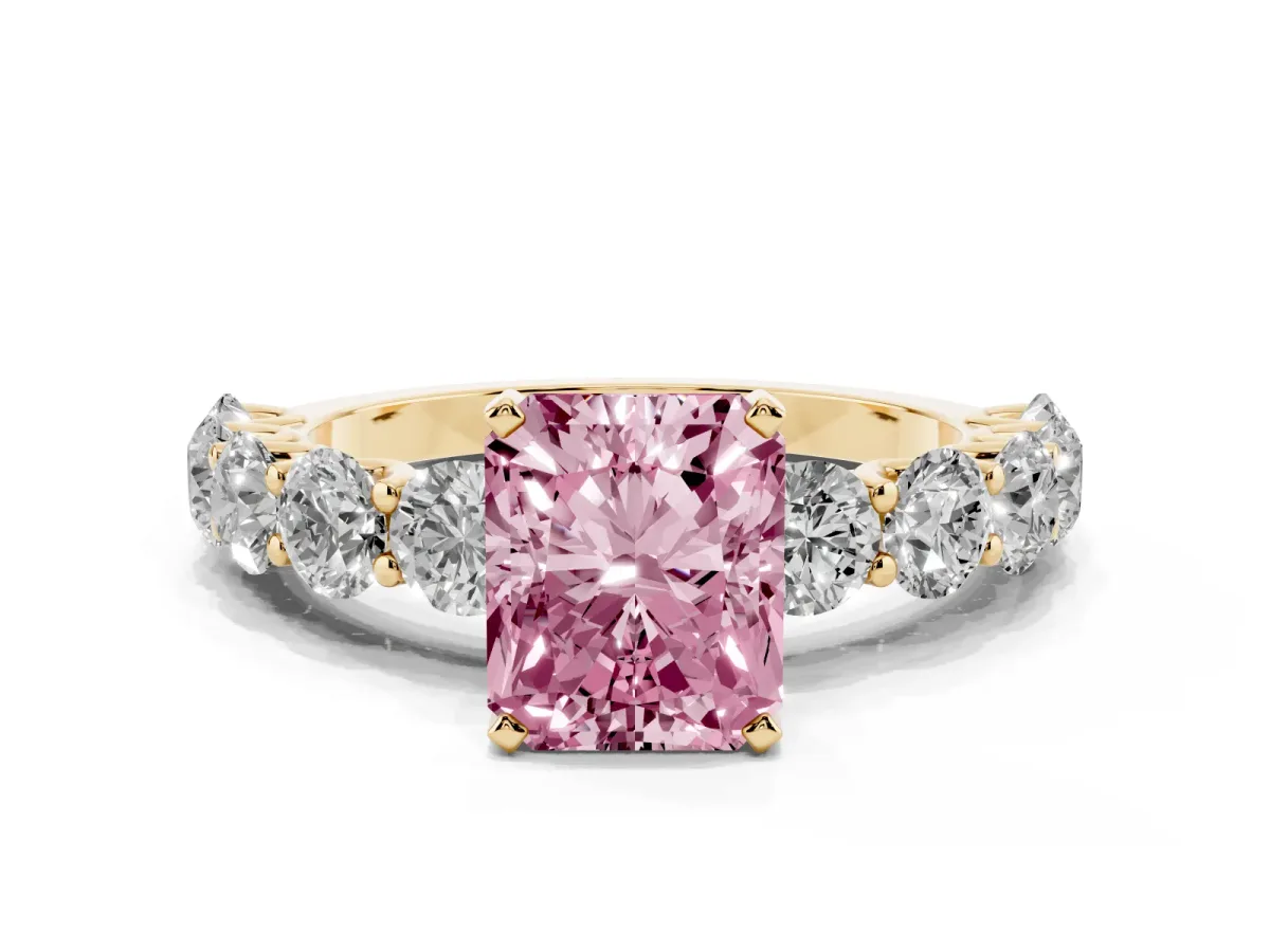 Fancy Pink Radiant Cut Diamond Prong Setting with Side Stones on a Pave Band Yellow gold