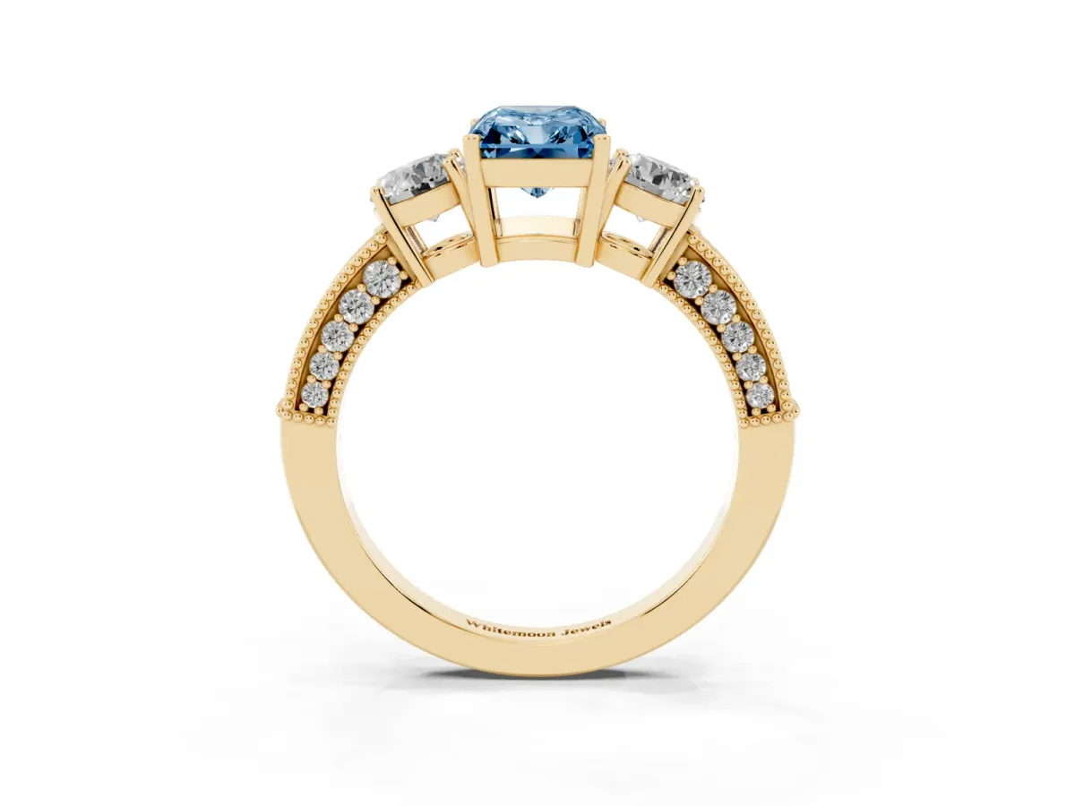 Fancy Blue Radiant Cut Three-Stone Diamond Ring with Pavé Band and Four-Prong Setting Yellow gold