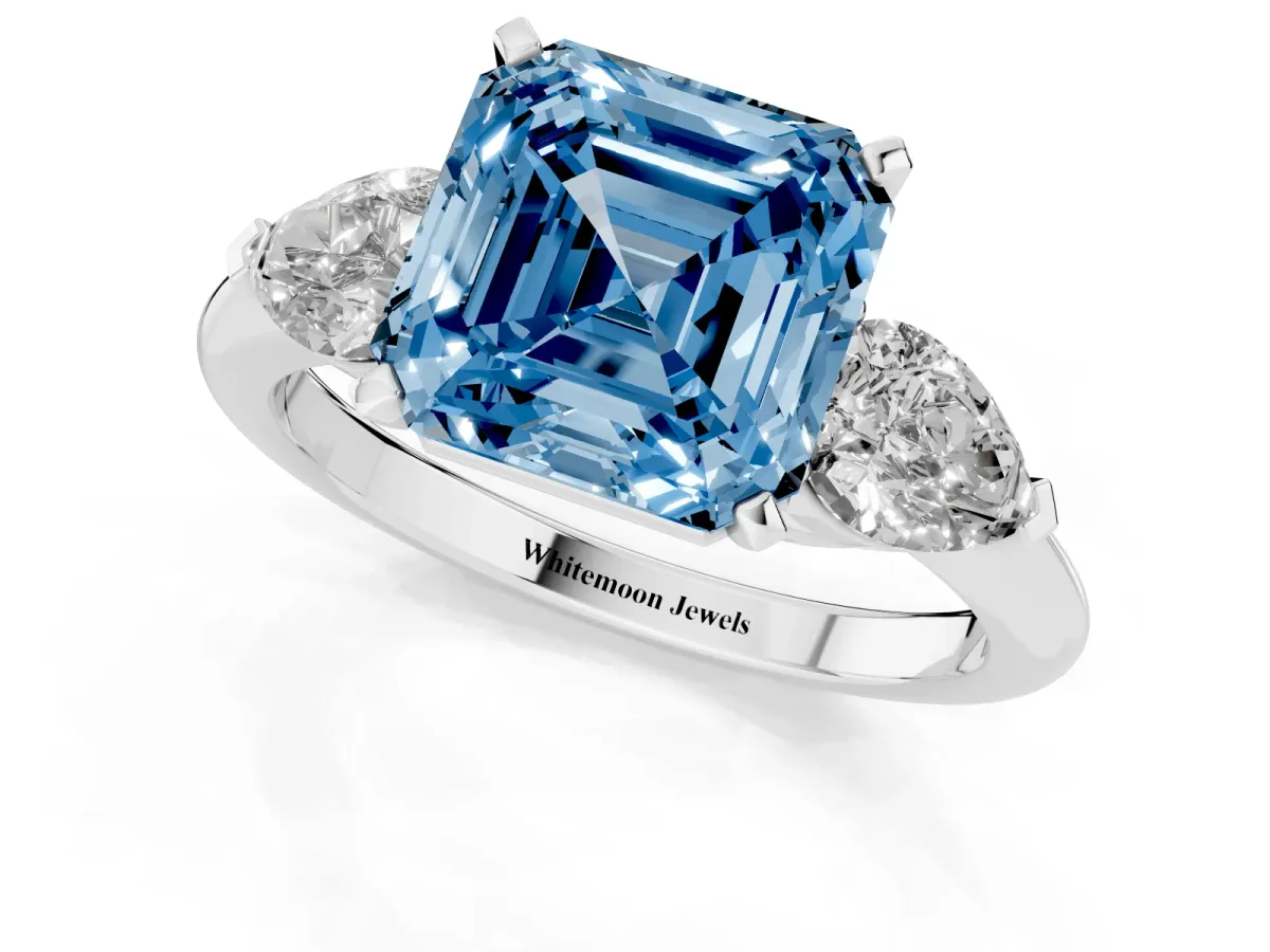 Fancy Blue Three-Stone Asscher Cut Diamond Ring with Pear Side Stones and Four-Prong Setting Platinum