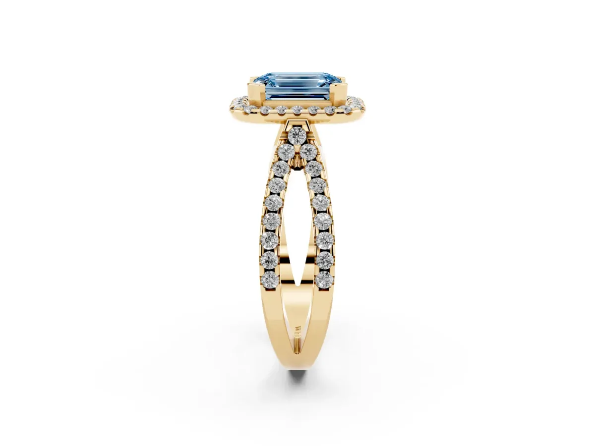 Fancy Blue Emerald Cut Diamond Halo Ring with Split Shank Pavé Band and Prong Setting Yellow gold