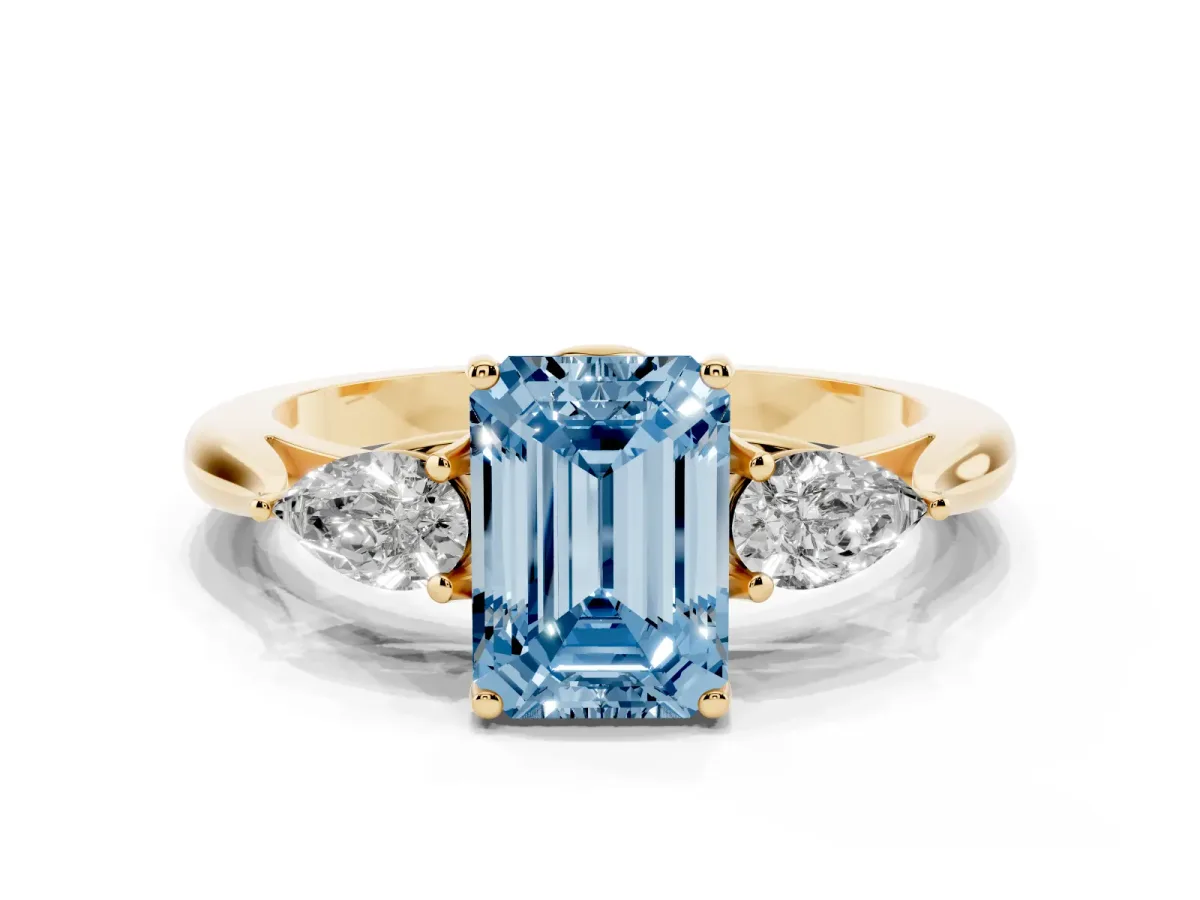 Fancy Blue Emerald Cut Diamond Three-Stone Ring with Pear Side Stones and Prong Setting Yellow gold