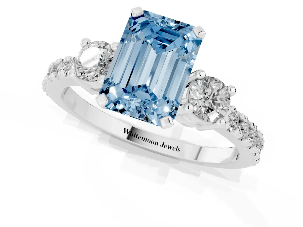Fancy Blue Emerald Cut Three-Stone Diamond Pavé Band with Prong Setting Platinum