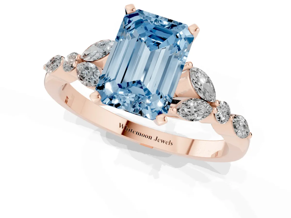 Fancy Blue Emerald Cut Diamond Solitaire Ring with Side Stones and Four-Prong Setting Rose gold
