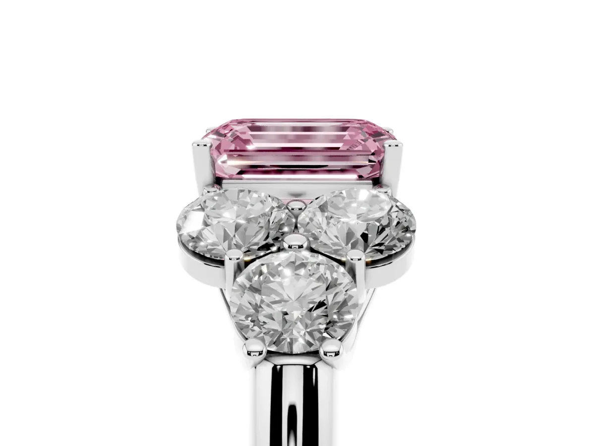 Fancy Pink Emerald Cut Cut Diamond Cluster Ring with Round Accent Stones and Prong Setting on a Classic Band Silver