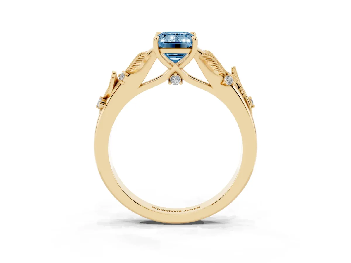 Fancy Blue Emerald Cut Diamond Solitaire Ring with Leaf Motif Band and Four-Prong Setting Yellow gold