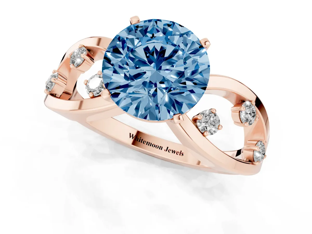 Fancy Blue Round Cut Cut Solitaire Diamond with Side Stones on Criss-Cross Band and Four-Prong Setting Rose gold