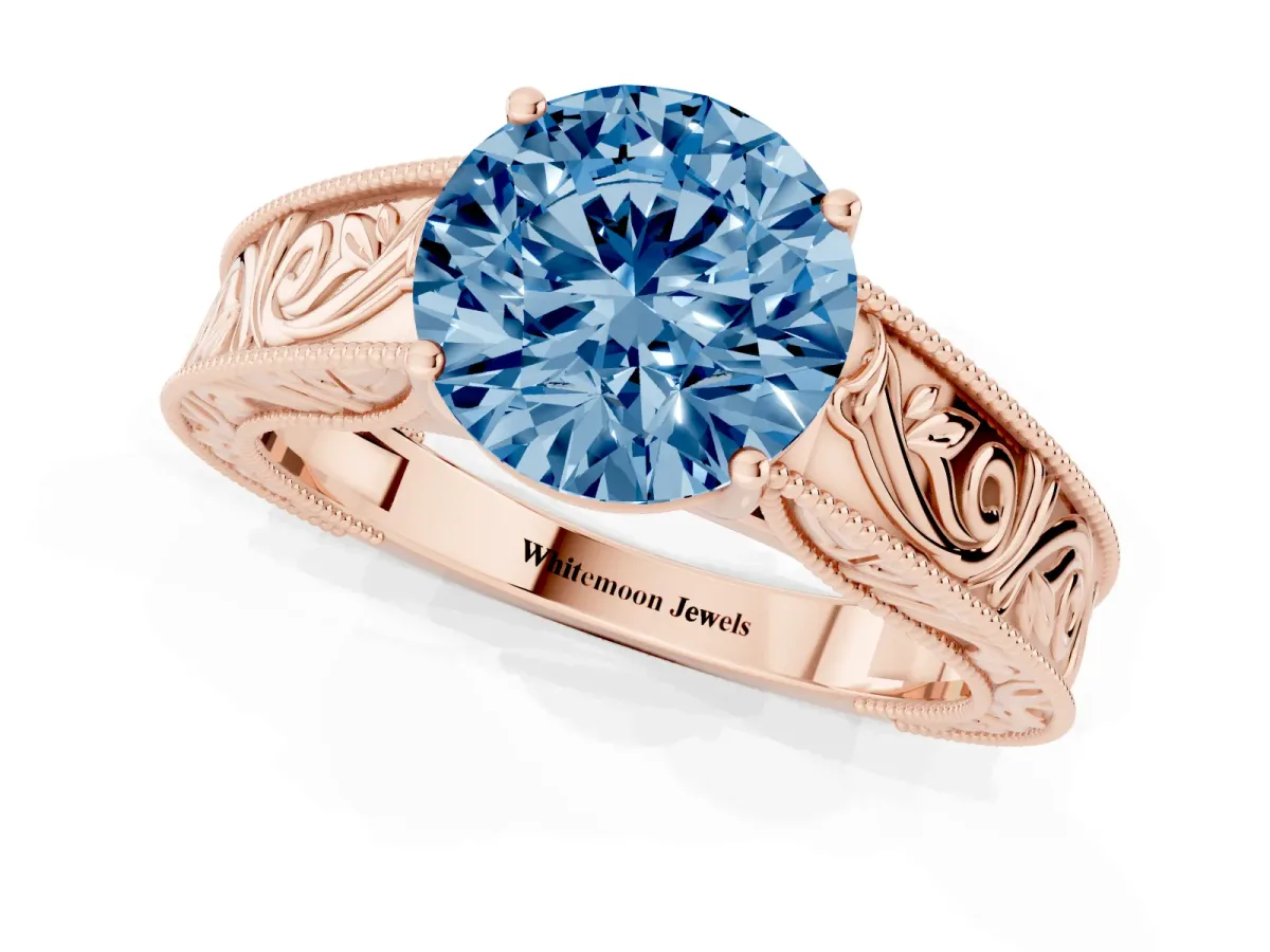 Fancy Blue Round Cut Diamond Solitaire Ring with Engraved Band and Four-Prong Setting Rose gold