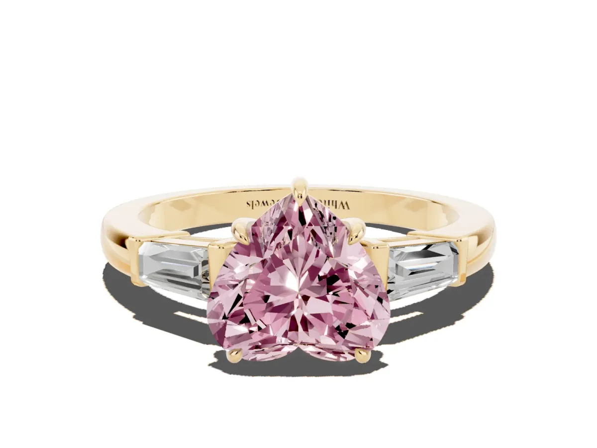 Fancy Pink Heart Cut Diamond Three-Stone Ring with Tapered Baguette Side Stones and Prong Setting Yellow gold