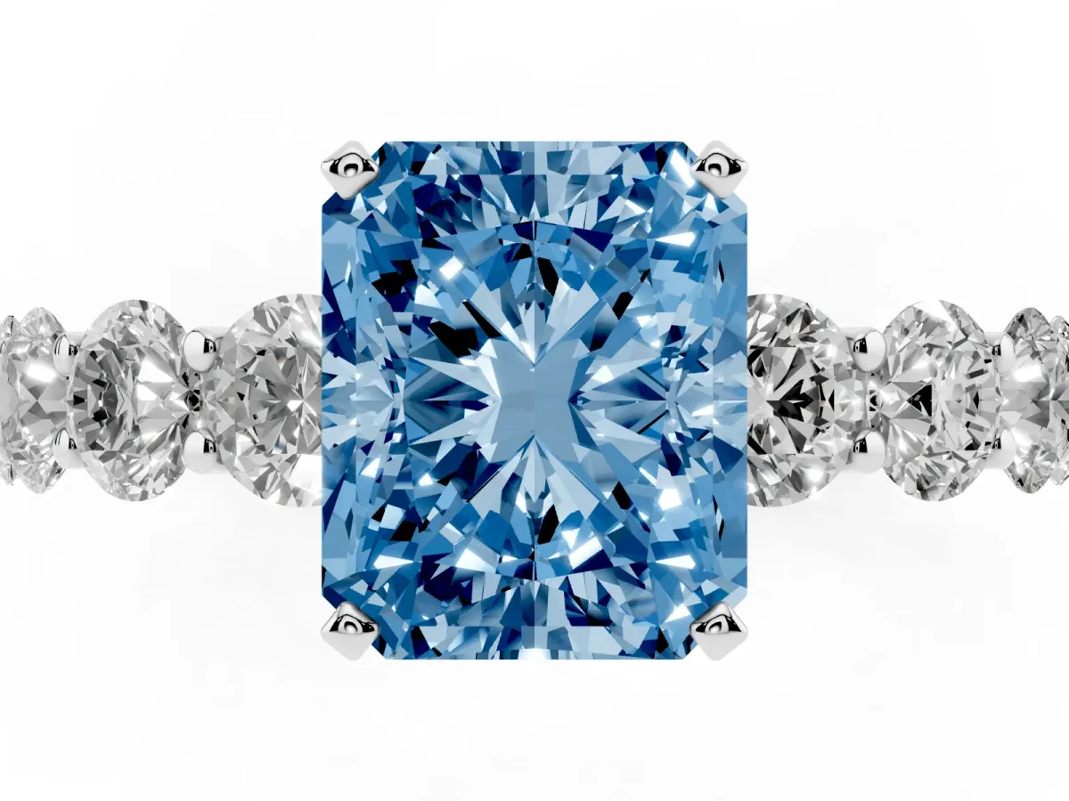 Fancy Blue Radiant Cut Diamond Prong Setting with Side Stones on a Pave Band Platinum