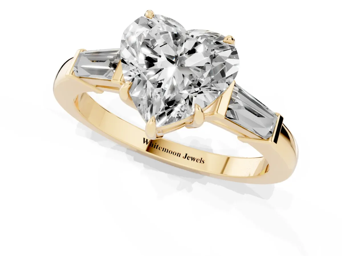 Heart Cut Diamond Three-Stone Ring with Tapered Baguette Side Stones and Prong Setting Yellow gold