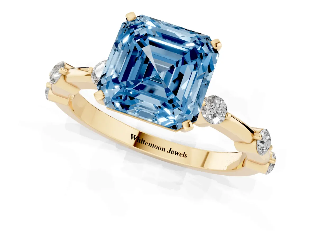 Fancy Blue Asscher Cut Solitaire Diamond Ring with Bezel Set Side Stones and Prong Setting Yellow gold