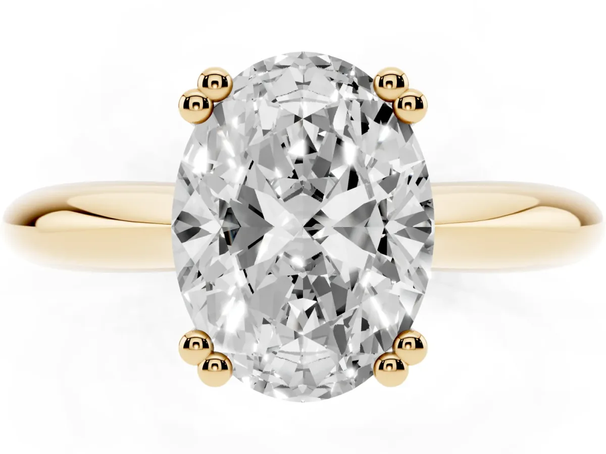 Oval Cut Cut Solitaire Engagement Ring with Tapered Band and Four-Prong Setting Yellow gold