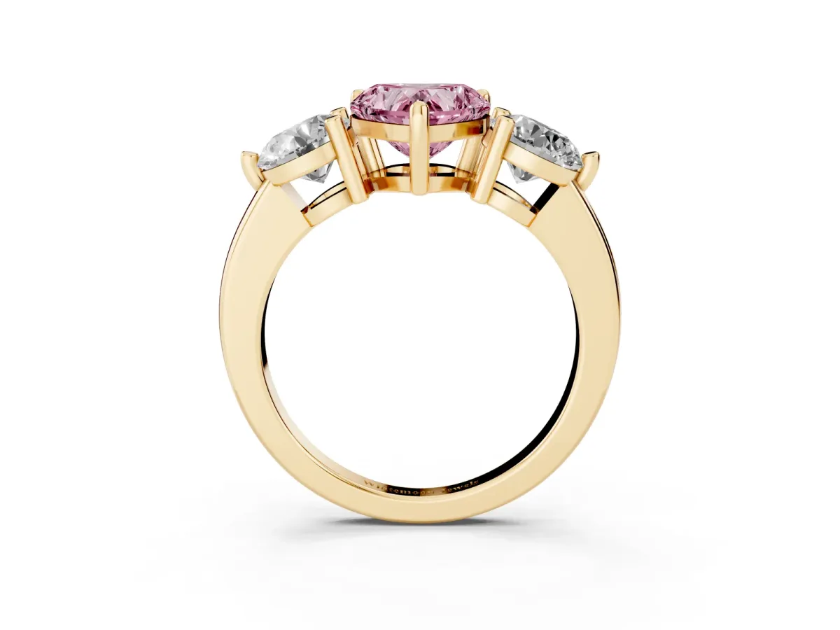 Fancy Pink Three-Stone Heart Cut Brilliant Cut Solitaire Ring with Prong Setting on a Classic Band Yellow gold