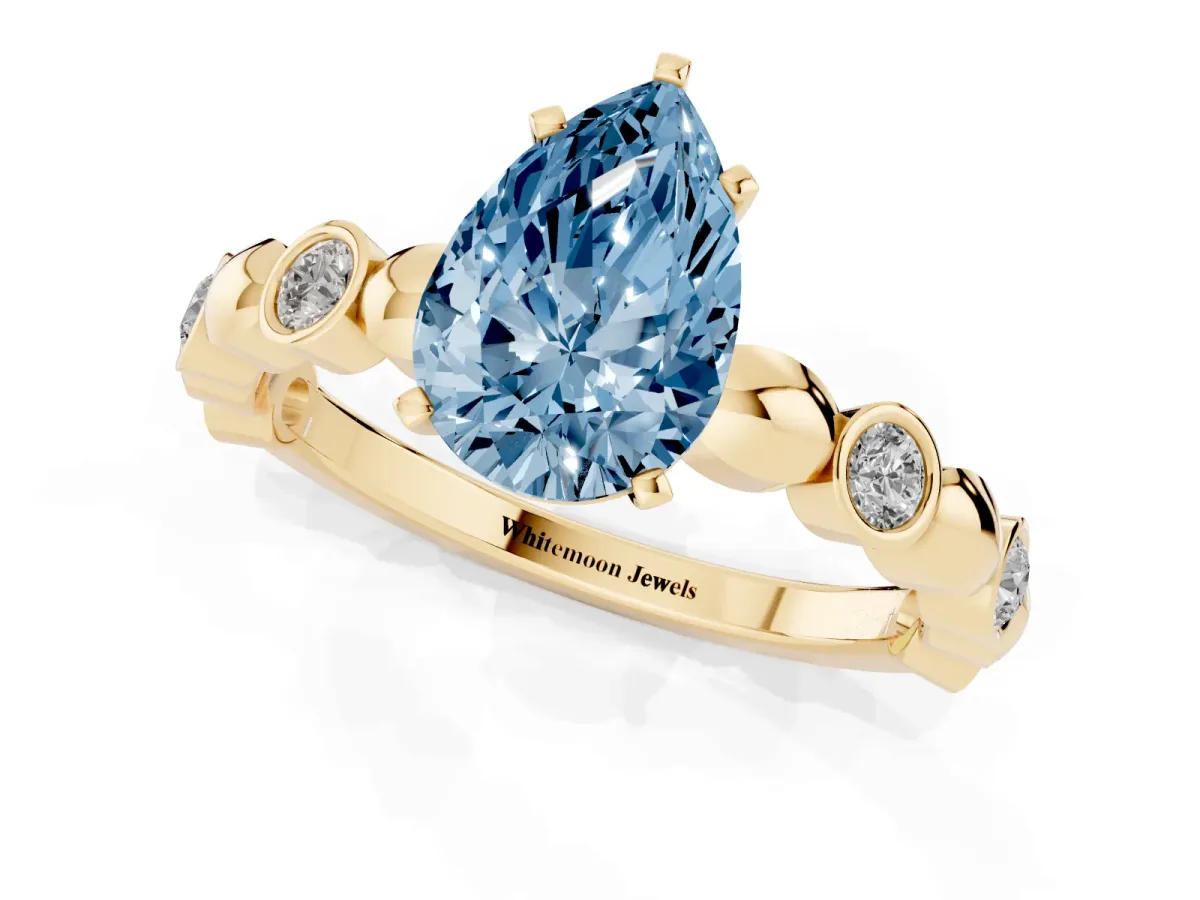 Fancy Blue Pear Cut Solitaire Bezel-Set Diamond Ring with Beaded Band and Four-Prong Setting Yellow gold