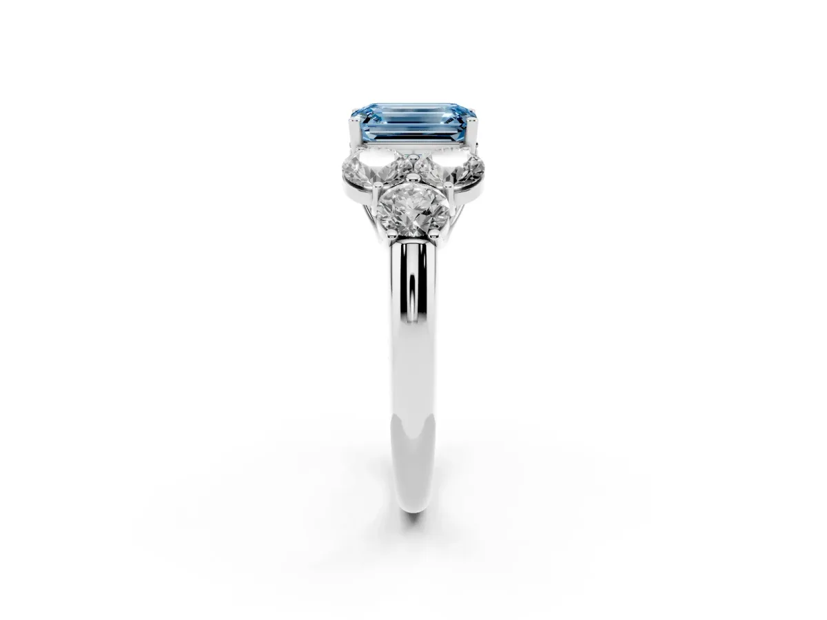 Fancy Blue Emerald Cut Cut Diamond Cluster Ring with Round Accent Stones and Prong Setting on a Classic Band White gold