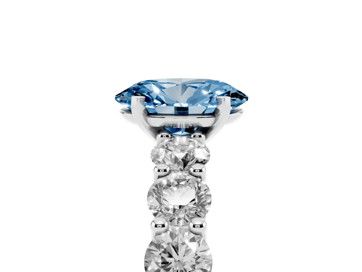 Fancy Blue Oval Cut Diamond Prong Setting with Side Stones on a Pave Band Silver
