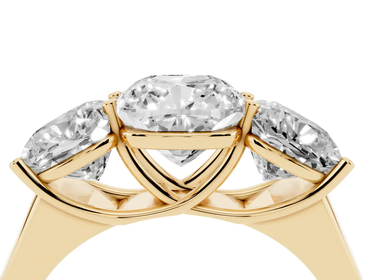 Cushion Cut Three-Stone Diamond Ring with Prong Setting on a Classic Band Yellow gold