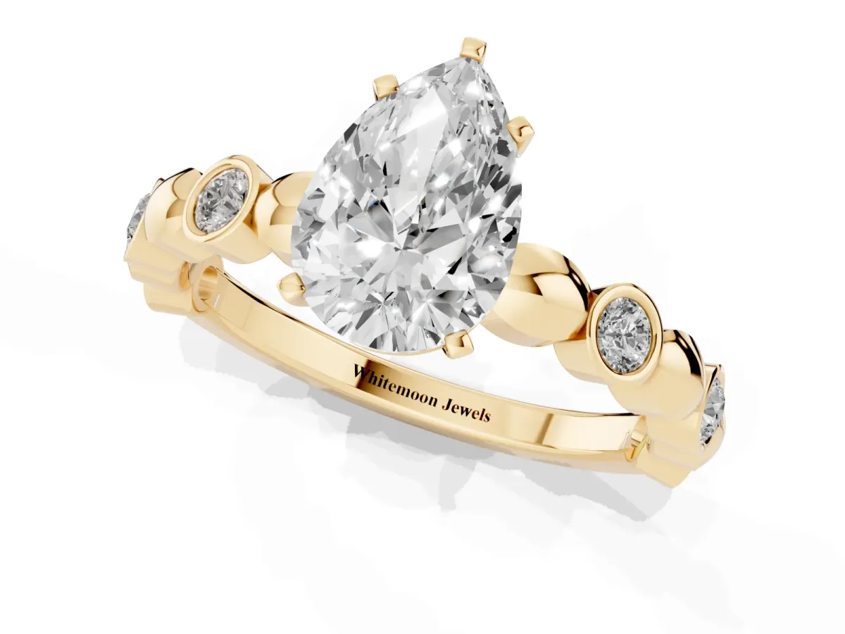 Pear Cut Solitaire Bezel-Set Diamond Ring with Beaded Band and Four-Prong Setting Yellow gold