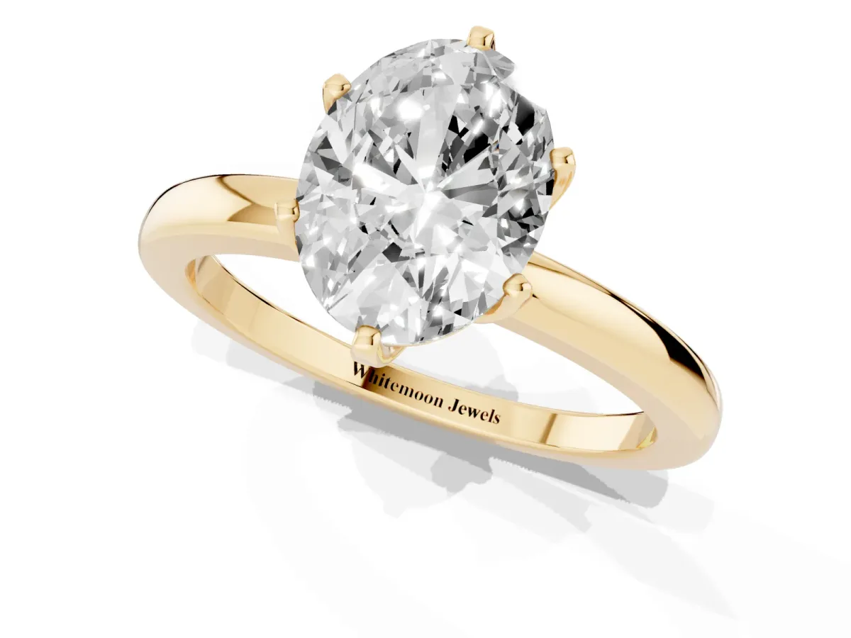 Oval Cut Solitaire Diamond Ring with Six-Prong Setting on a Classic Band Yellow gold